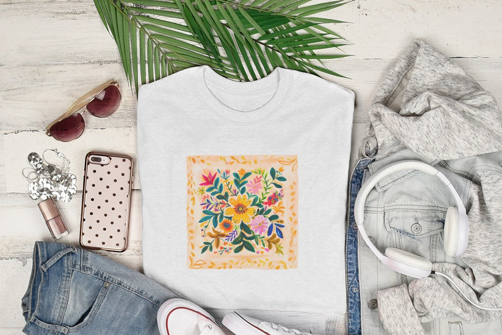 White t-shirt with colorful floral square design, styled with jeans, headphones, and sunglasses.