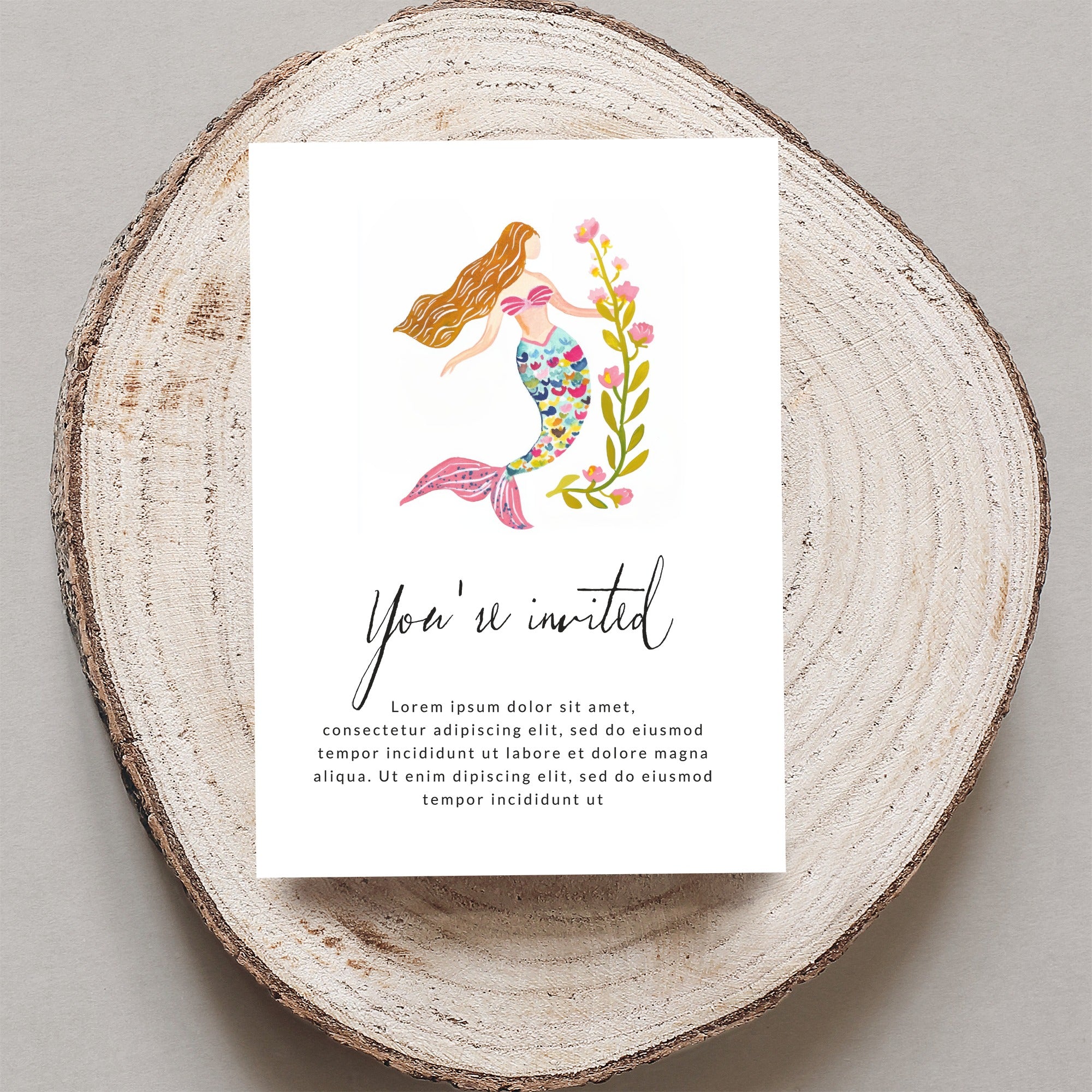Invitation card with watercolor mermaid and floral design.