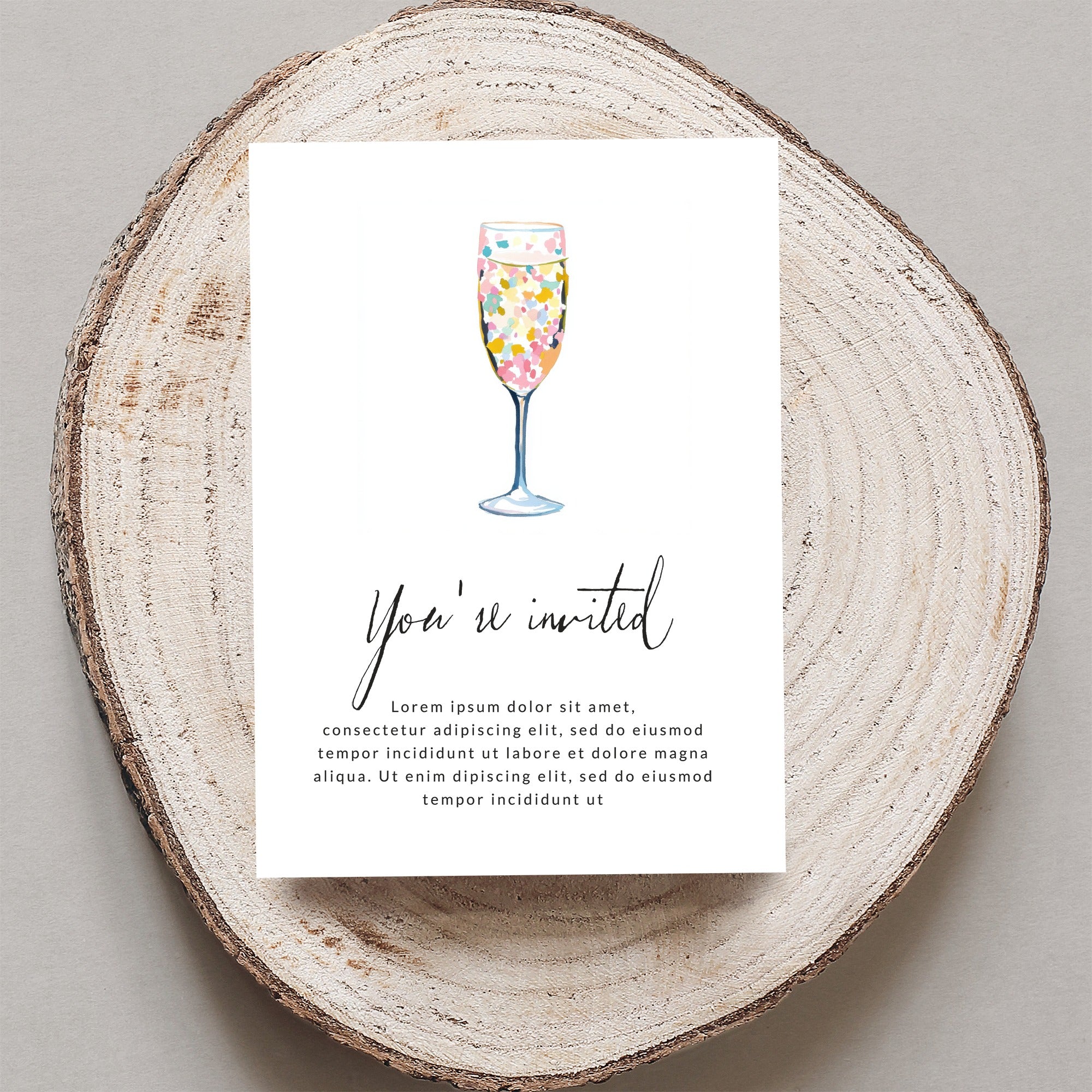 Invitation with "You're invited" text and champagne flute with colorful confetti.
