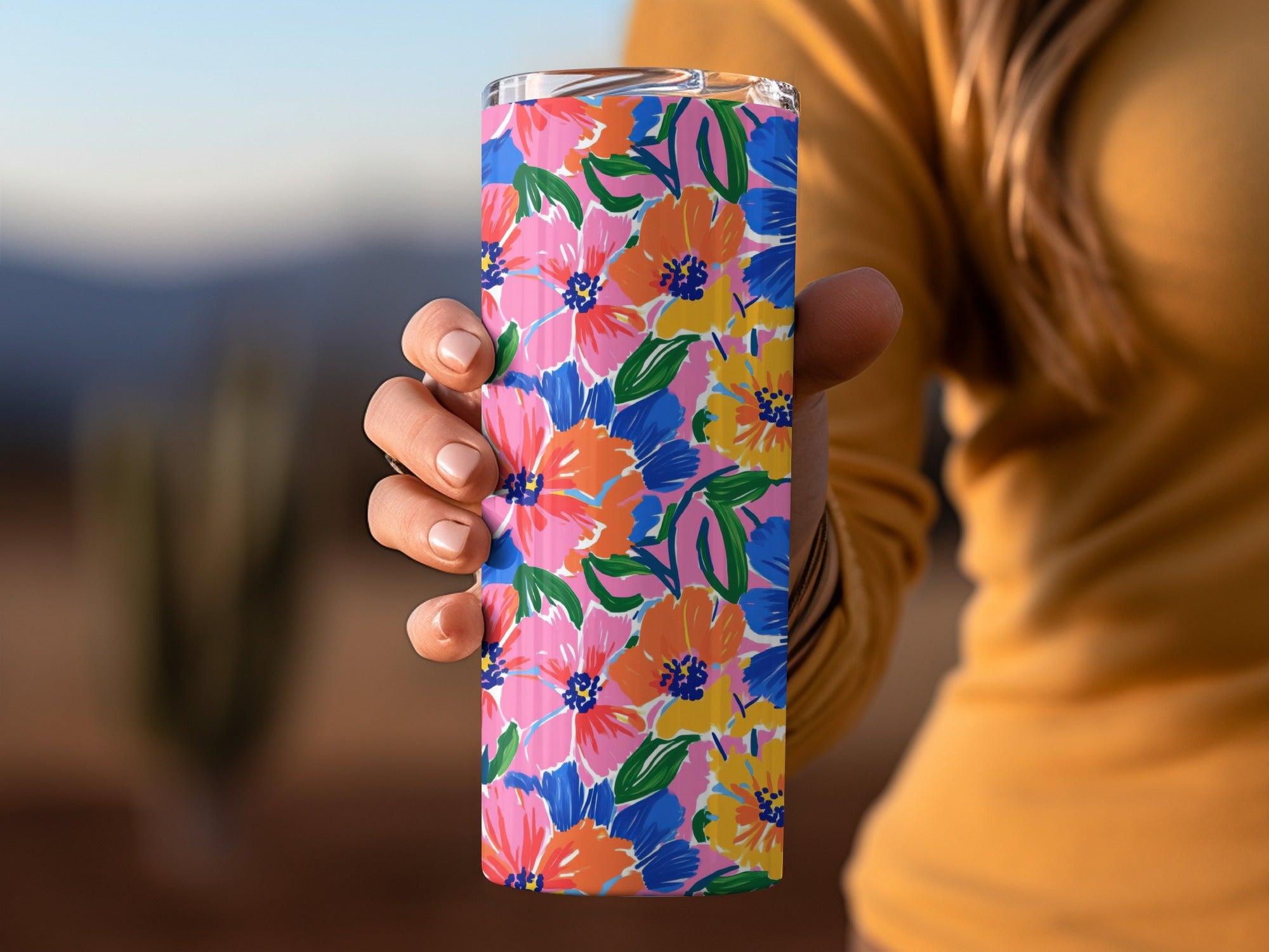 Tall tumbler with a vibrant floral pattern in pink, blue, orange, and yellow.