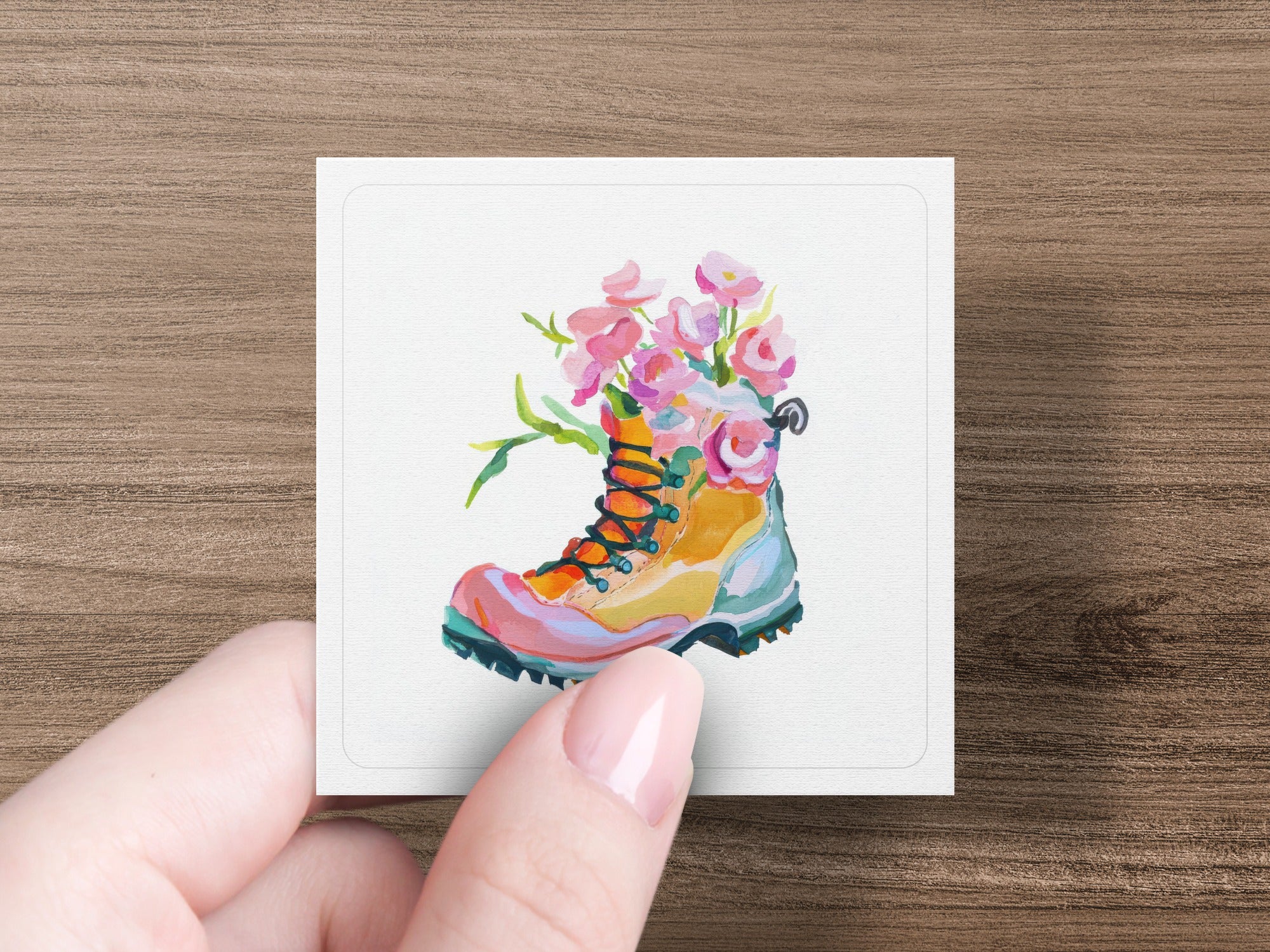 Watercolor illustration of a hiking boot with colorful flowers growing from it.