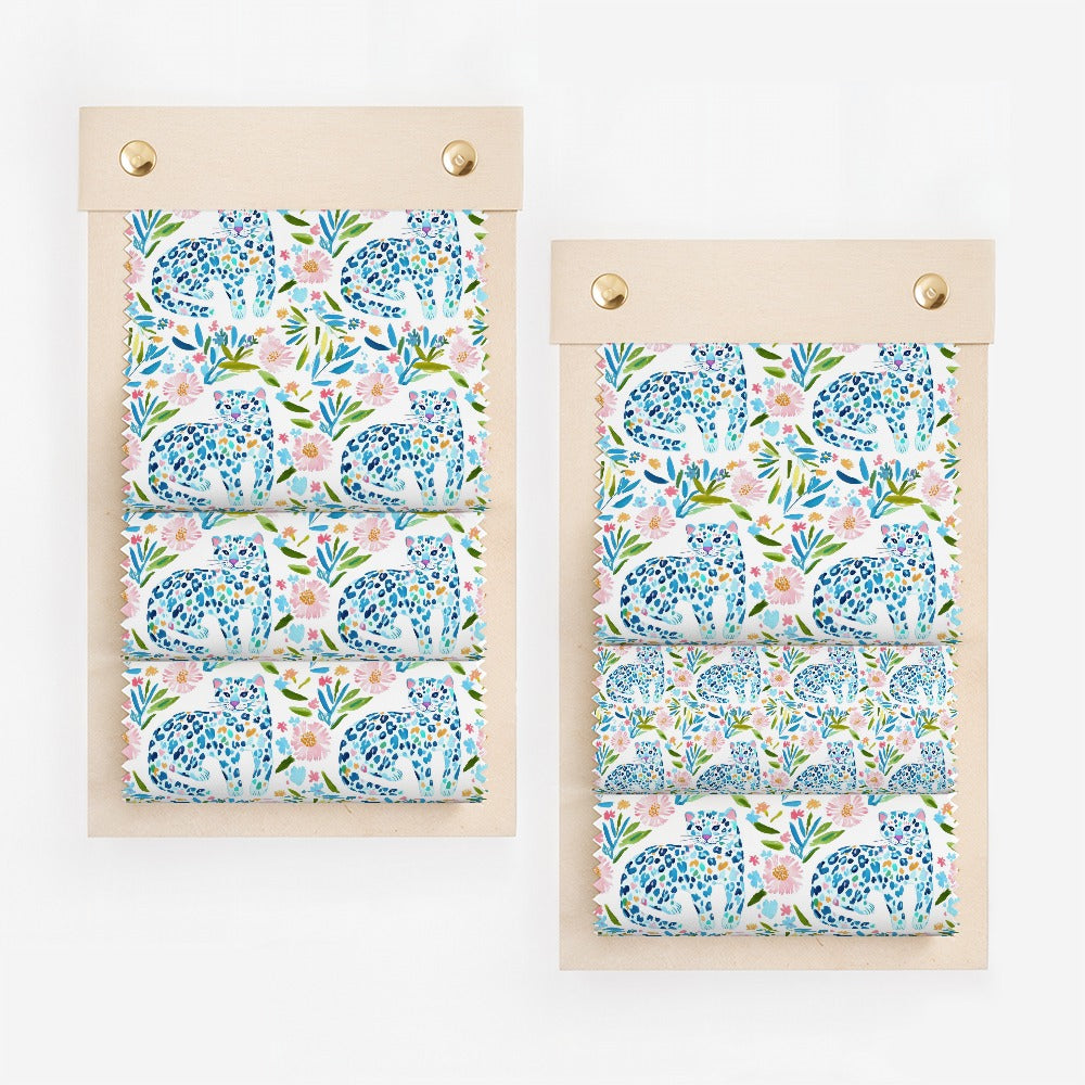 Swatches of blue leopard print fabric with pink and green floral accents.