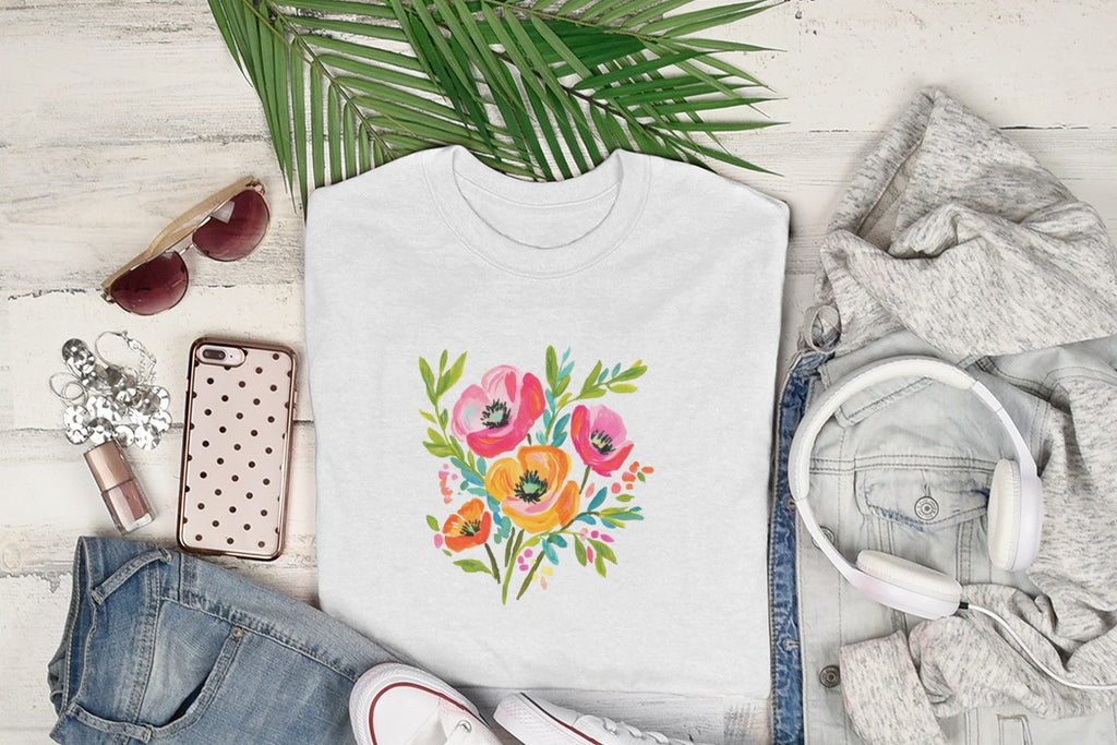 White t-shirt with colorful floral print, laid flat with accessories.