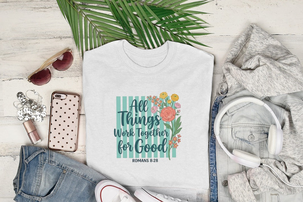 White t-shirt with "All Things Work For Good Romans 8:28" floral design.