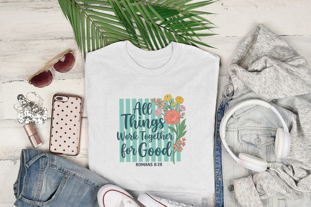 White t-shirt with "All Things Work For Good Romans 8:28" floral design.