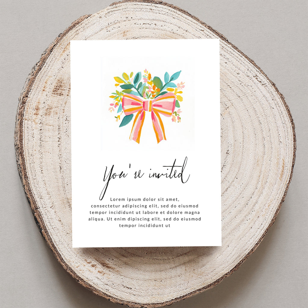 Invitation card with "You're invited" and placeholder text on wood slice.