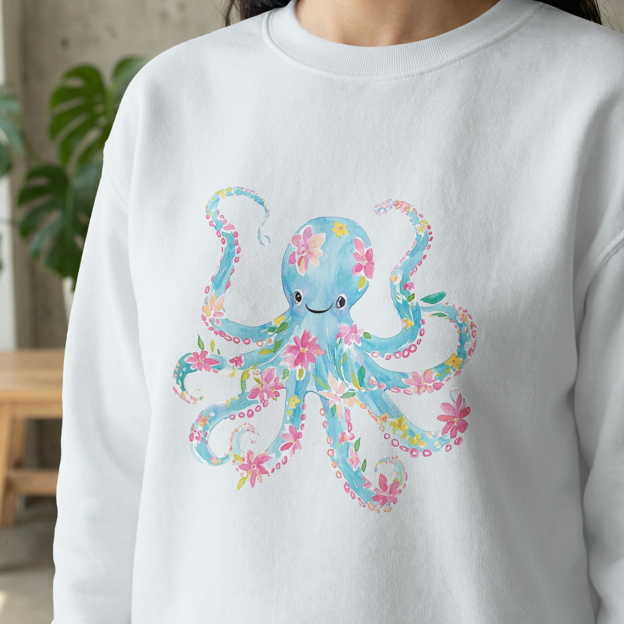 White sweatshirt with blue octopus design and floral accents.