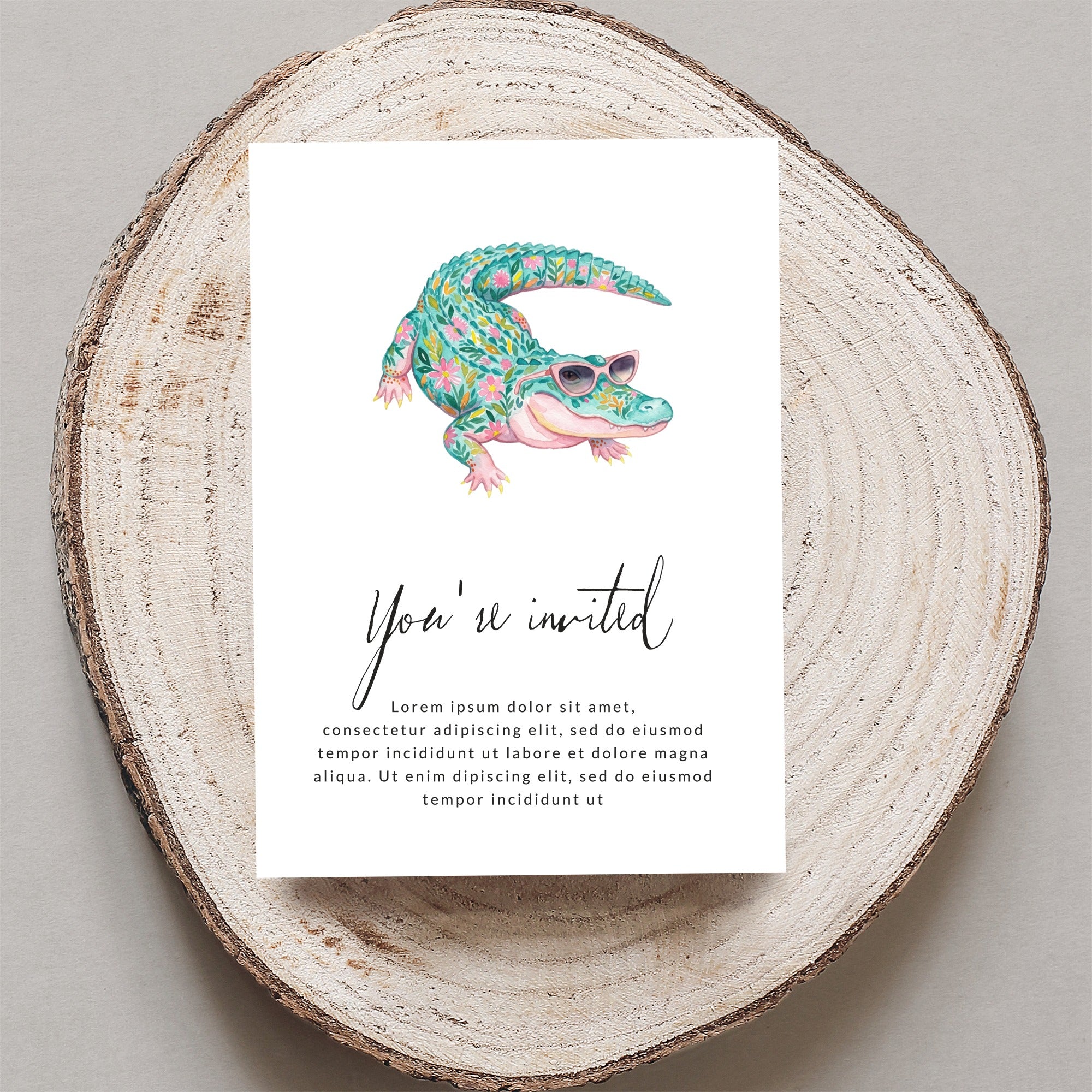 Invitation card with a cartoon alligator wearing sunglasses and floral decorations.