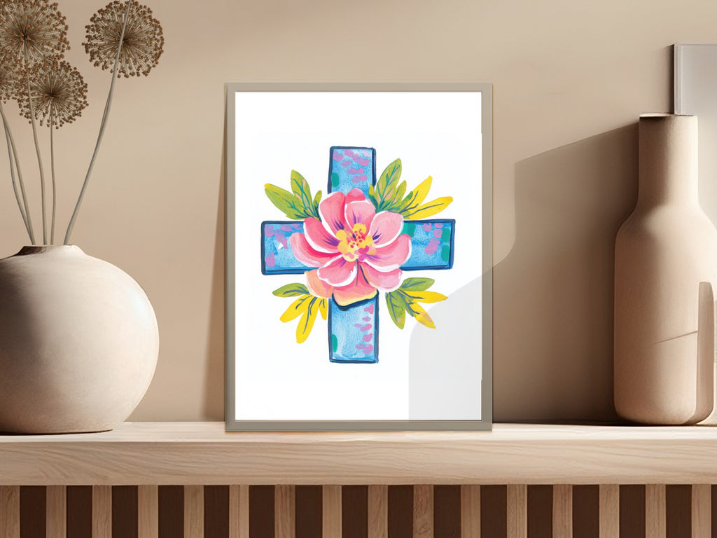 Watercolor painting of a pink flower on a blue cross with yellow leaves.