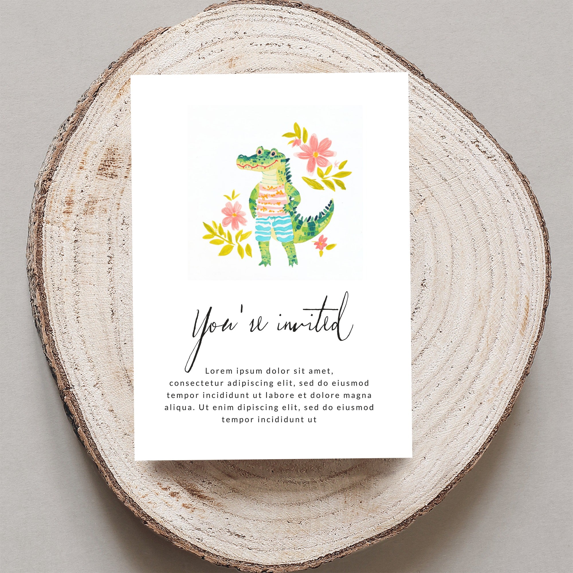 Invitation card with a cartoon alligator and floral illustrations.
