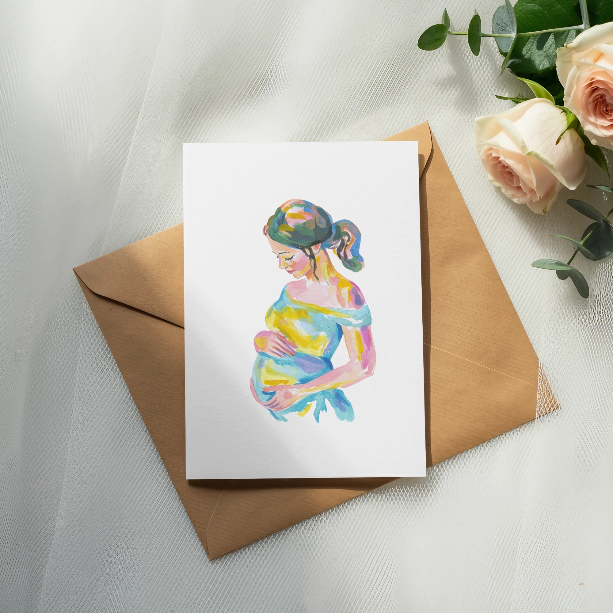 Watercolor painting of a pregnant woman on a card, placed on a brown envelope.
