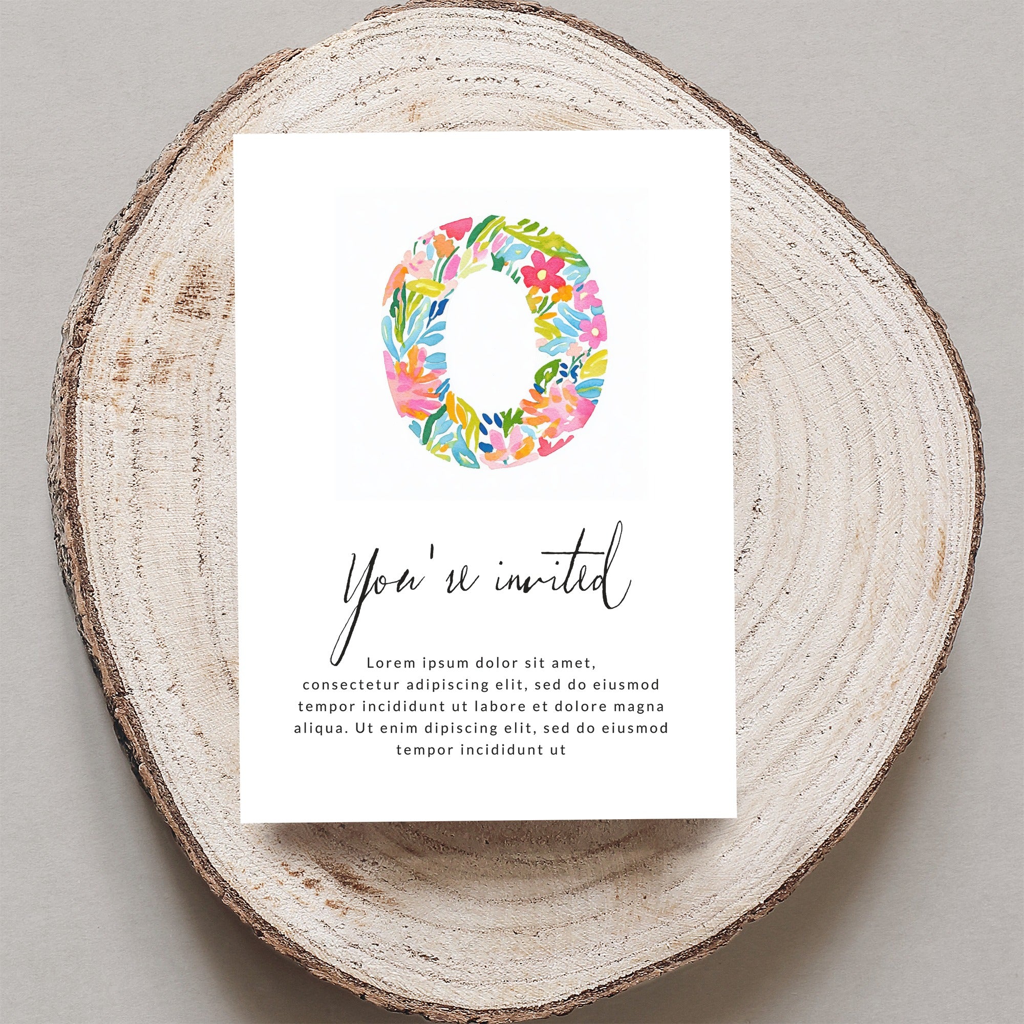 Invitation with floral letter "O" and placeholder text.
