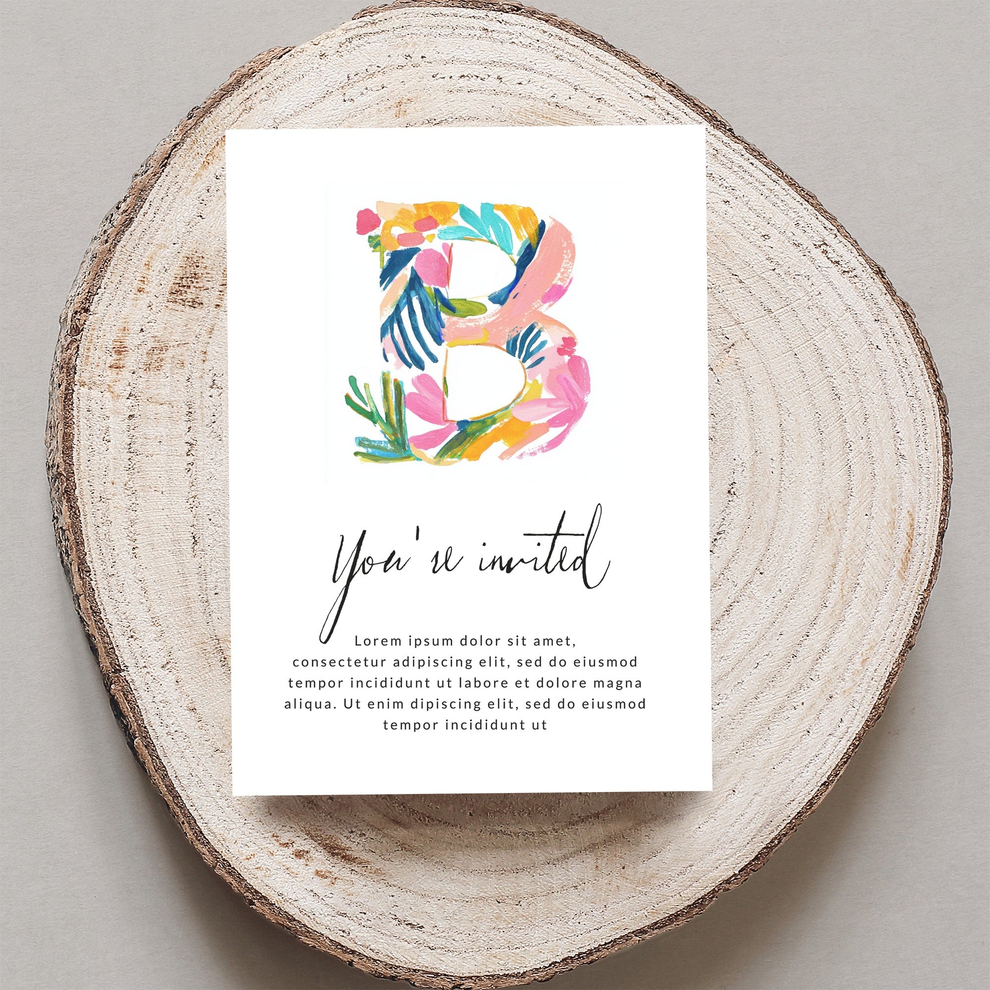 Invitation card with "You're invited" and floral letter B.