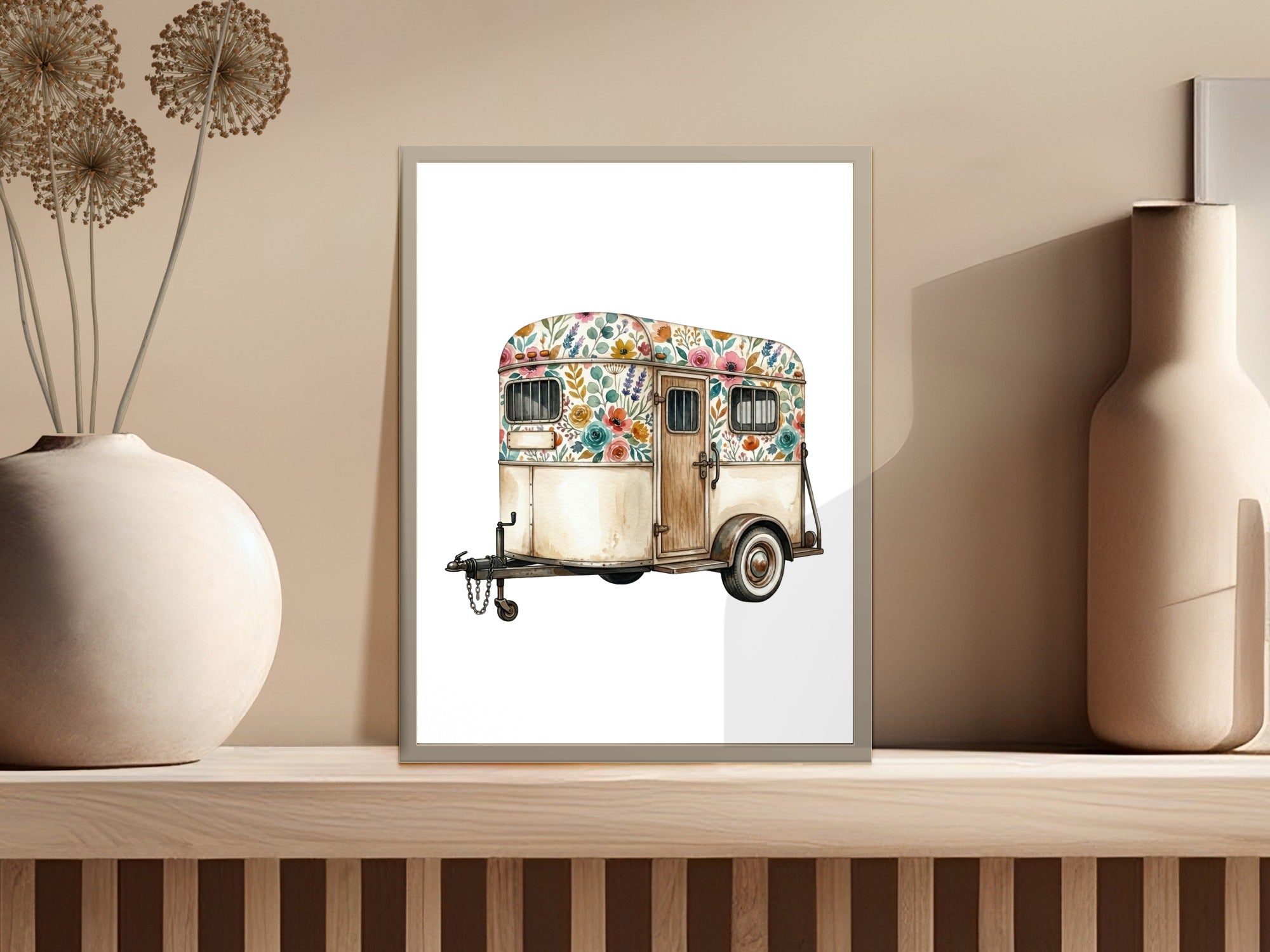 Watercolor illustration of a floral-patterned camper trailer on a shelf.