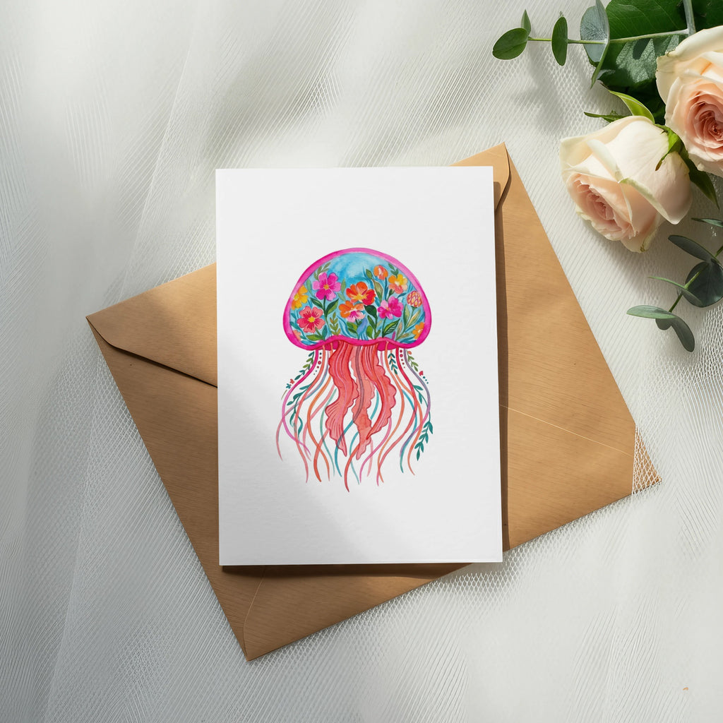 Watercolor jellyfish illustration with floral details on a greeting card.
