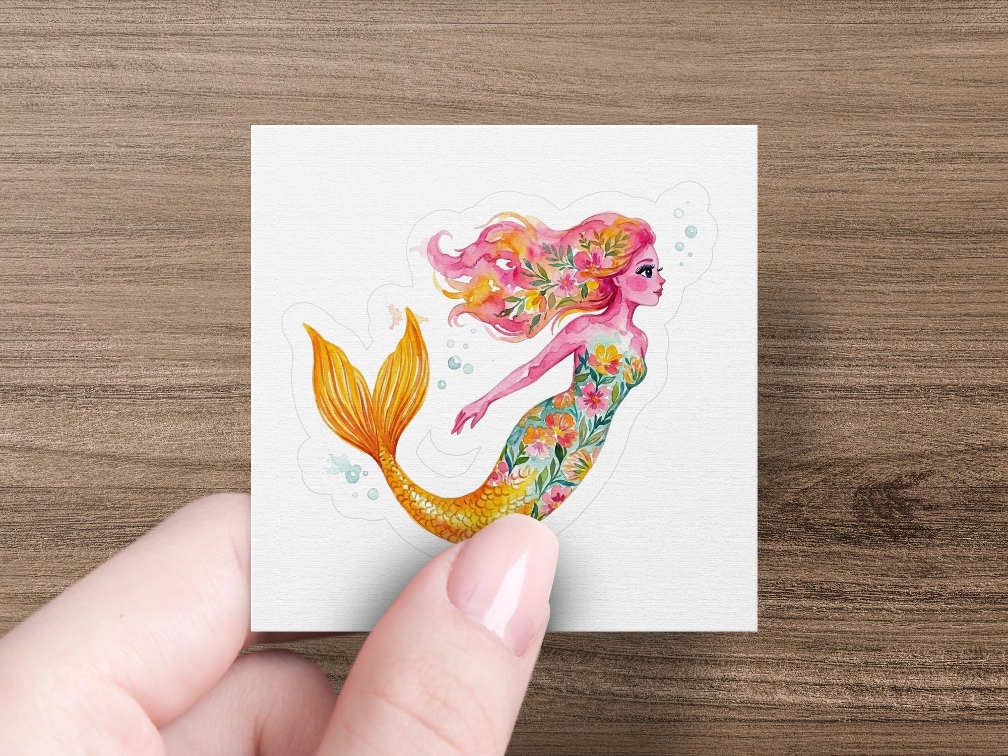 Whimsical mermaid with floral tail and hair, swimming right.