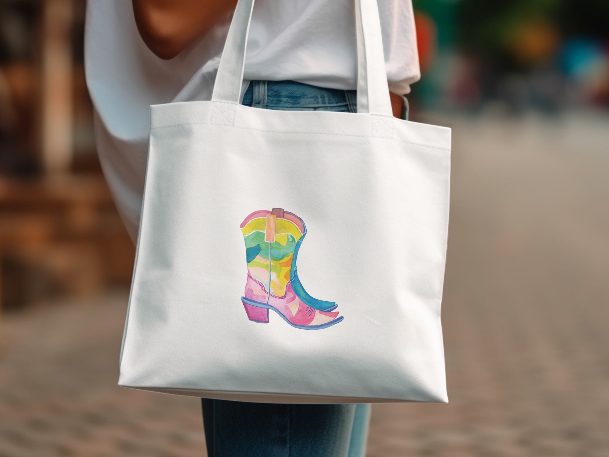 White tote bag with colorful cowboy boot design.