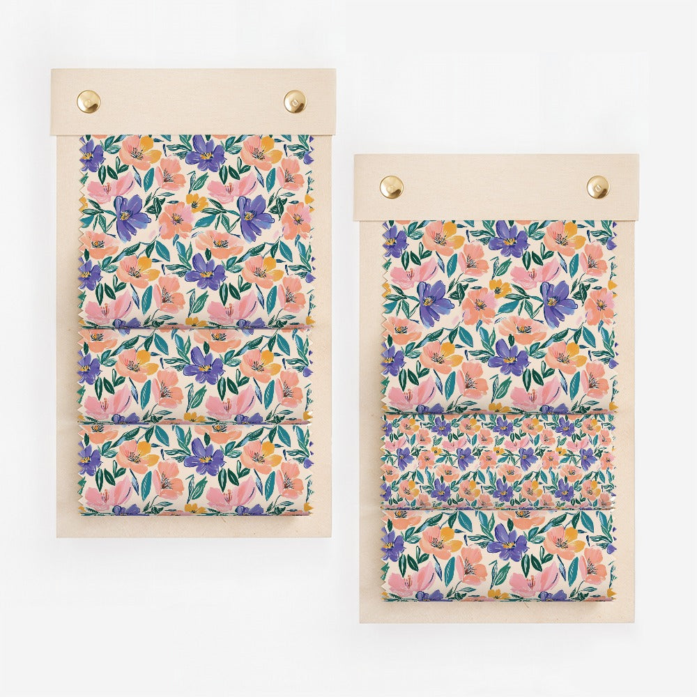 Two swatches of fabric with a floral print of pink, purple, and yellow flowers.