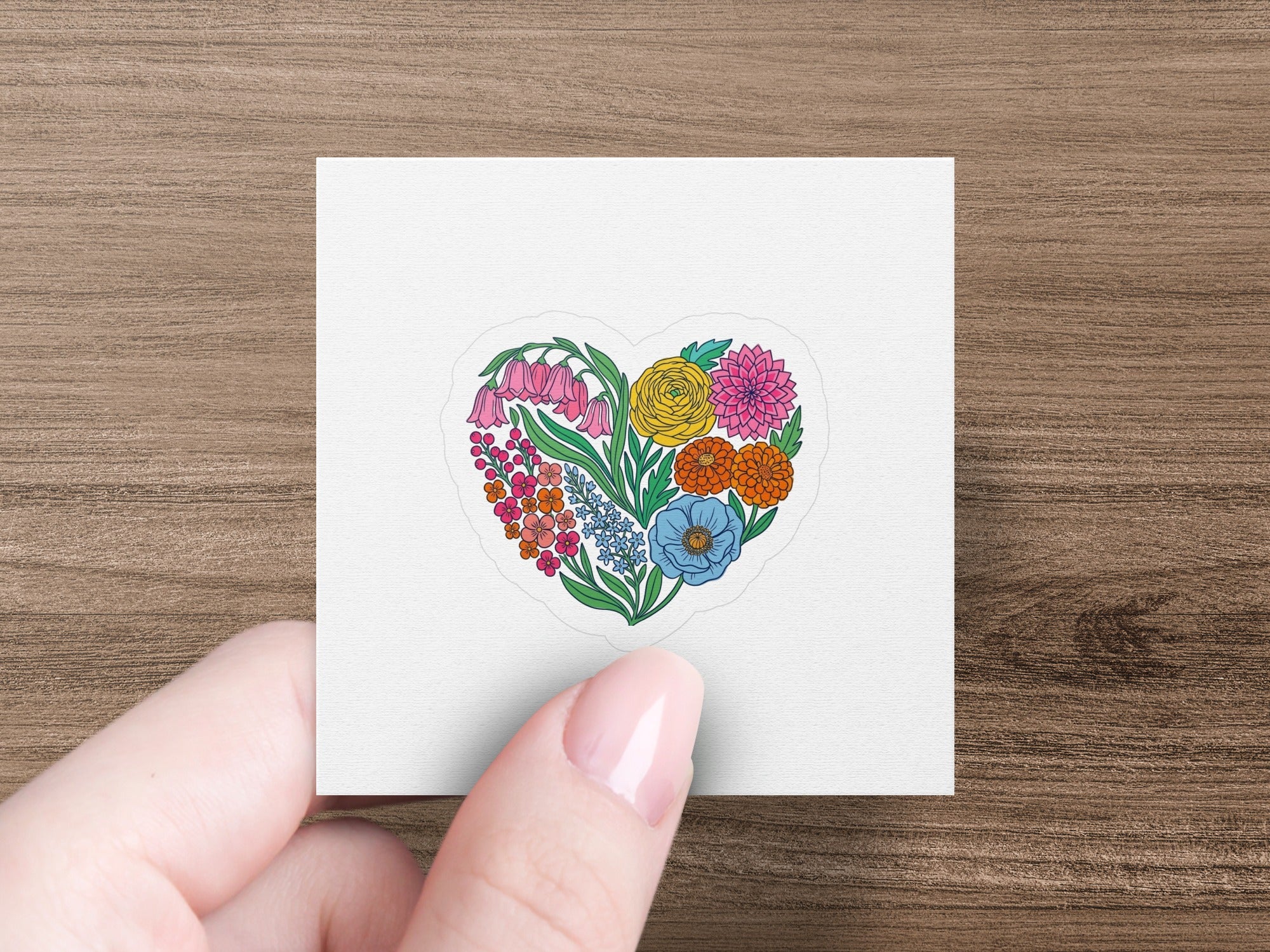 Heart-shaped floral sticker with colorful blooms on a white square.