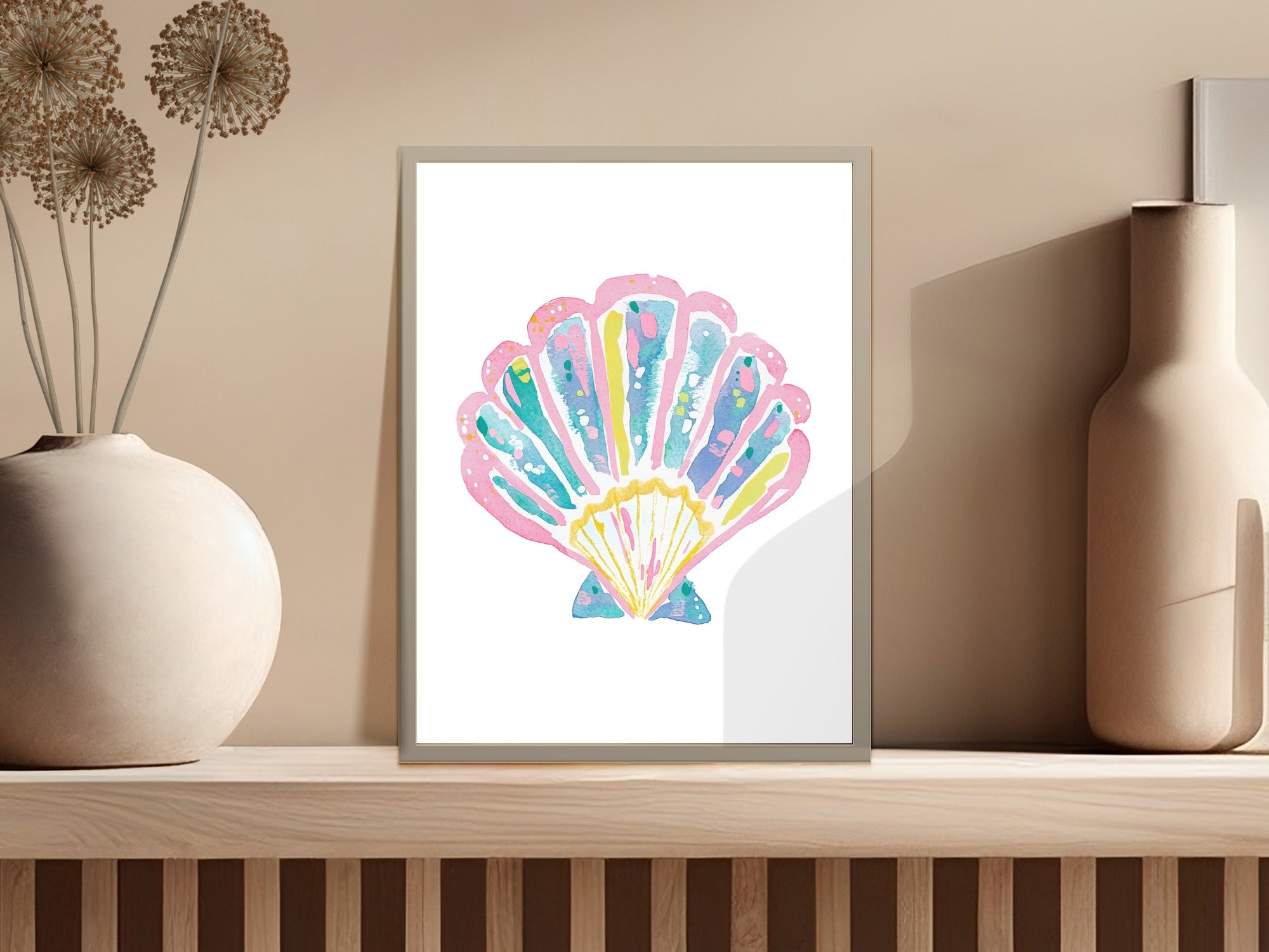 Pink, blue, and yellow watercolor scallop shell artwork in a white frame.