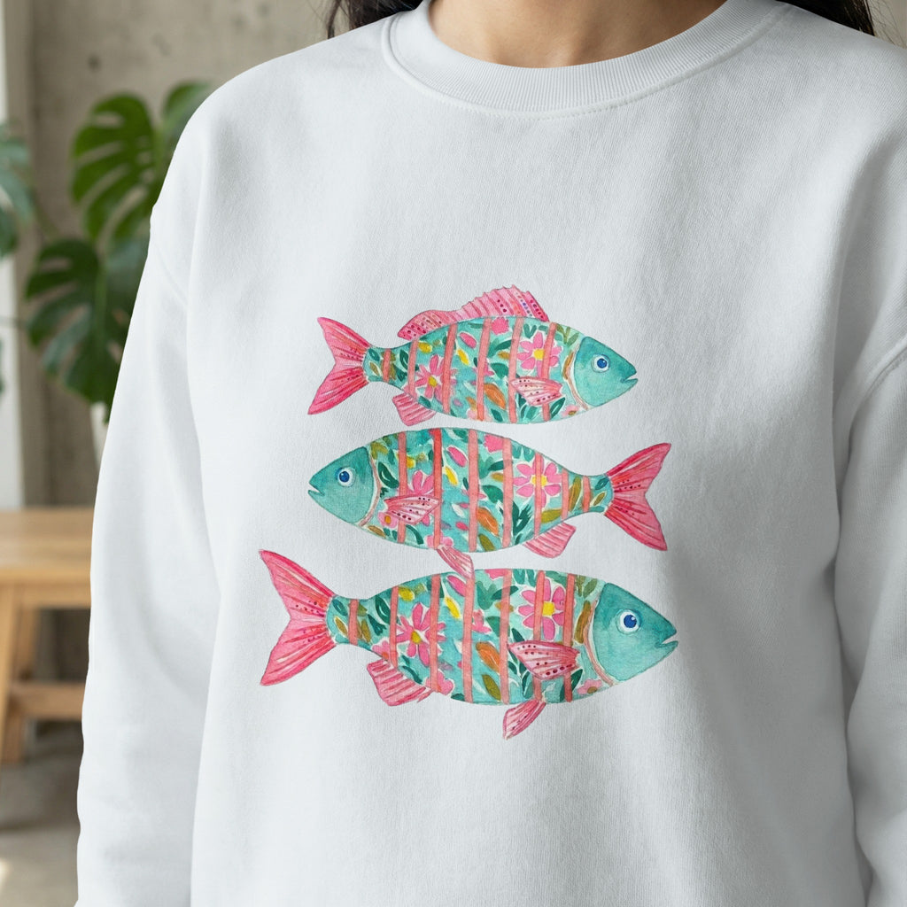 Three colorful, stylized fish with floral patterns on a white sweatshirt.