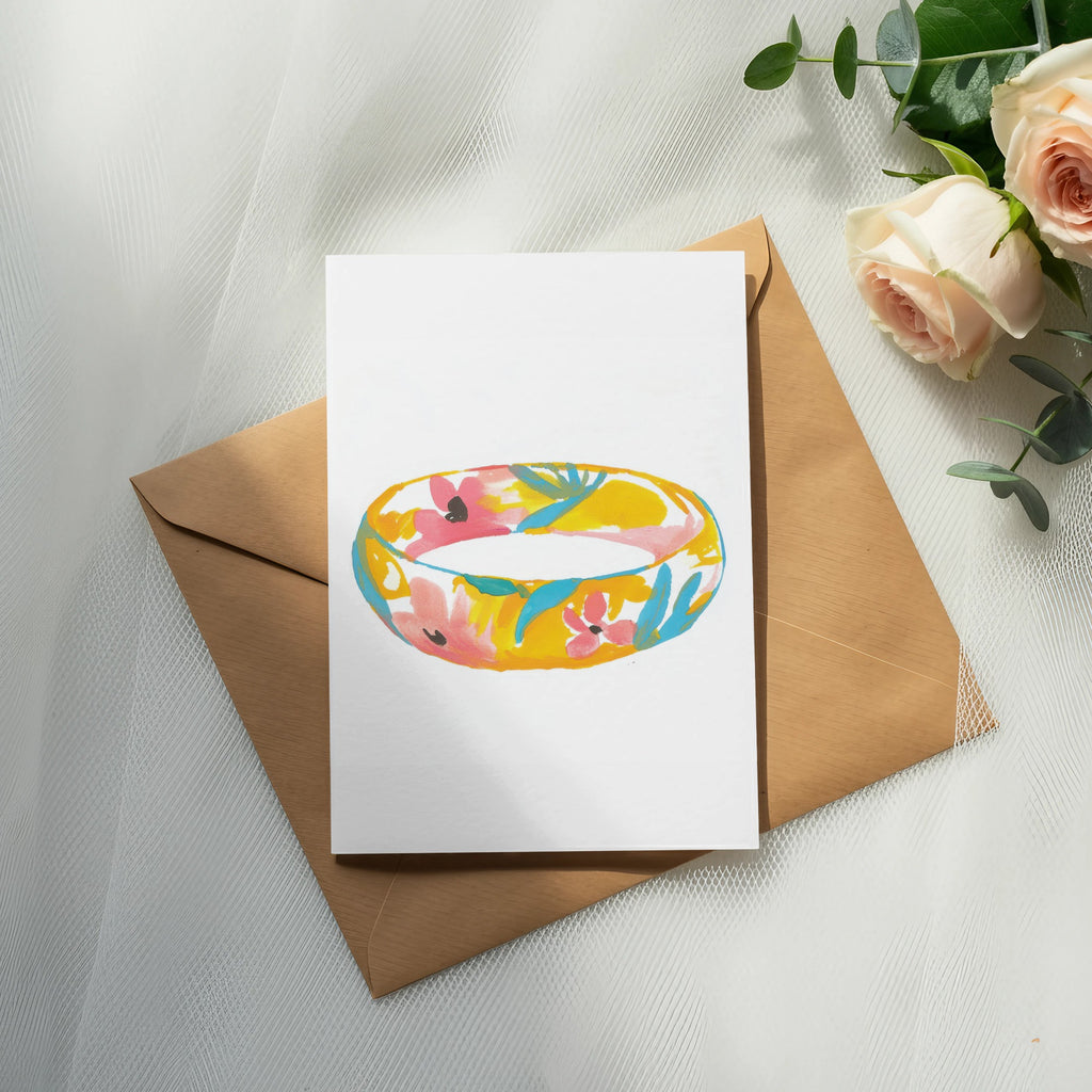 Card with floral ring illustration on brown envelope with roses.