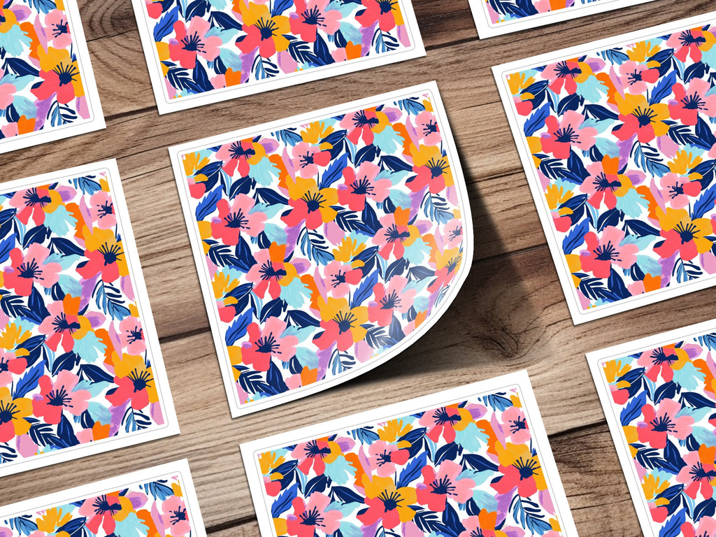 Floral pattern on white cards scattered on a wooden surface.