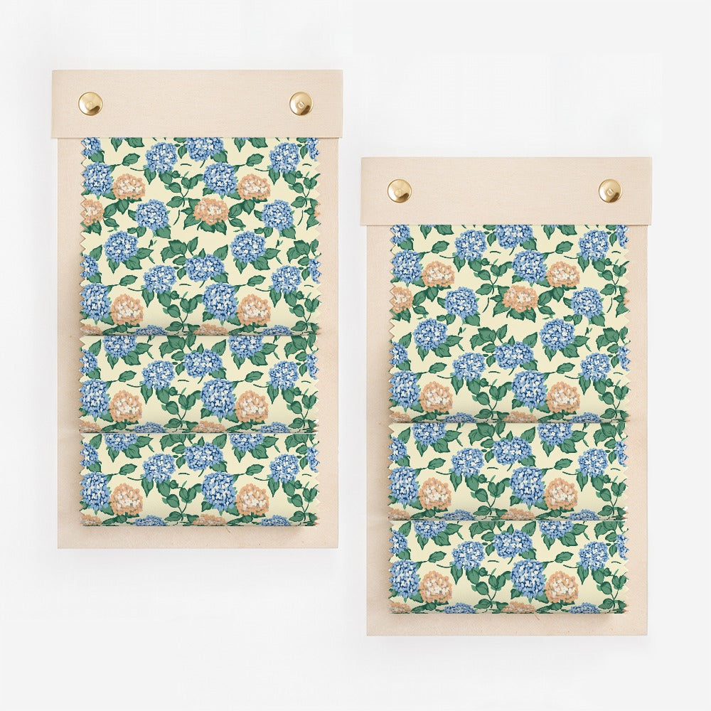 Floral fabric swatches with blue and orange flowers and green leaves.