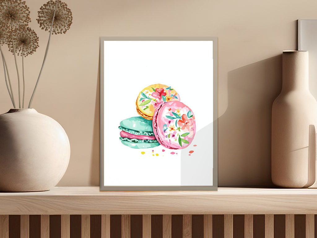 Watercolor illustration of three colorful macarons with floral designs on a shelf.