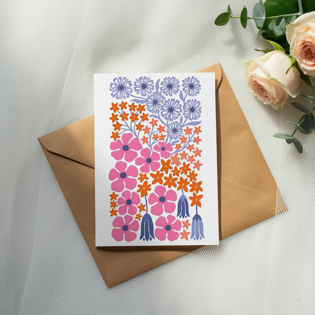 Card with pink, orange, and purple floral designs on a brown envelope.