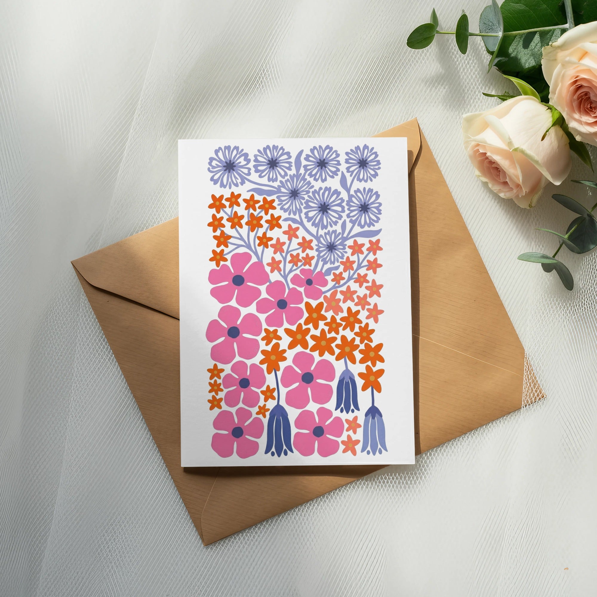 Card with pink, orange, and purple floral designs on a brown envelope.