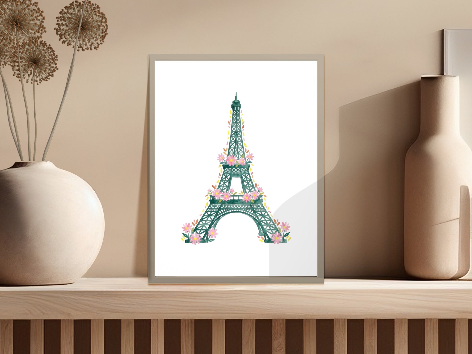 Eiffel Tower illustration with pink flowers on a wooden shelf.