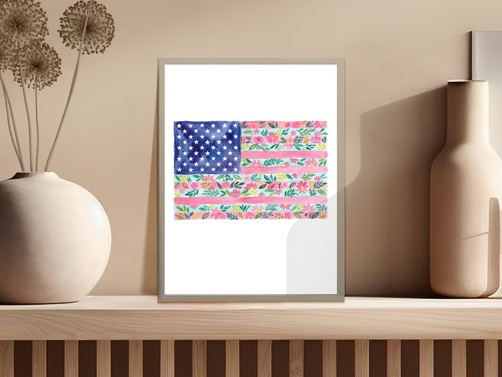 Watercolor American flag with floral stripes and stars on a shelf.