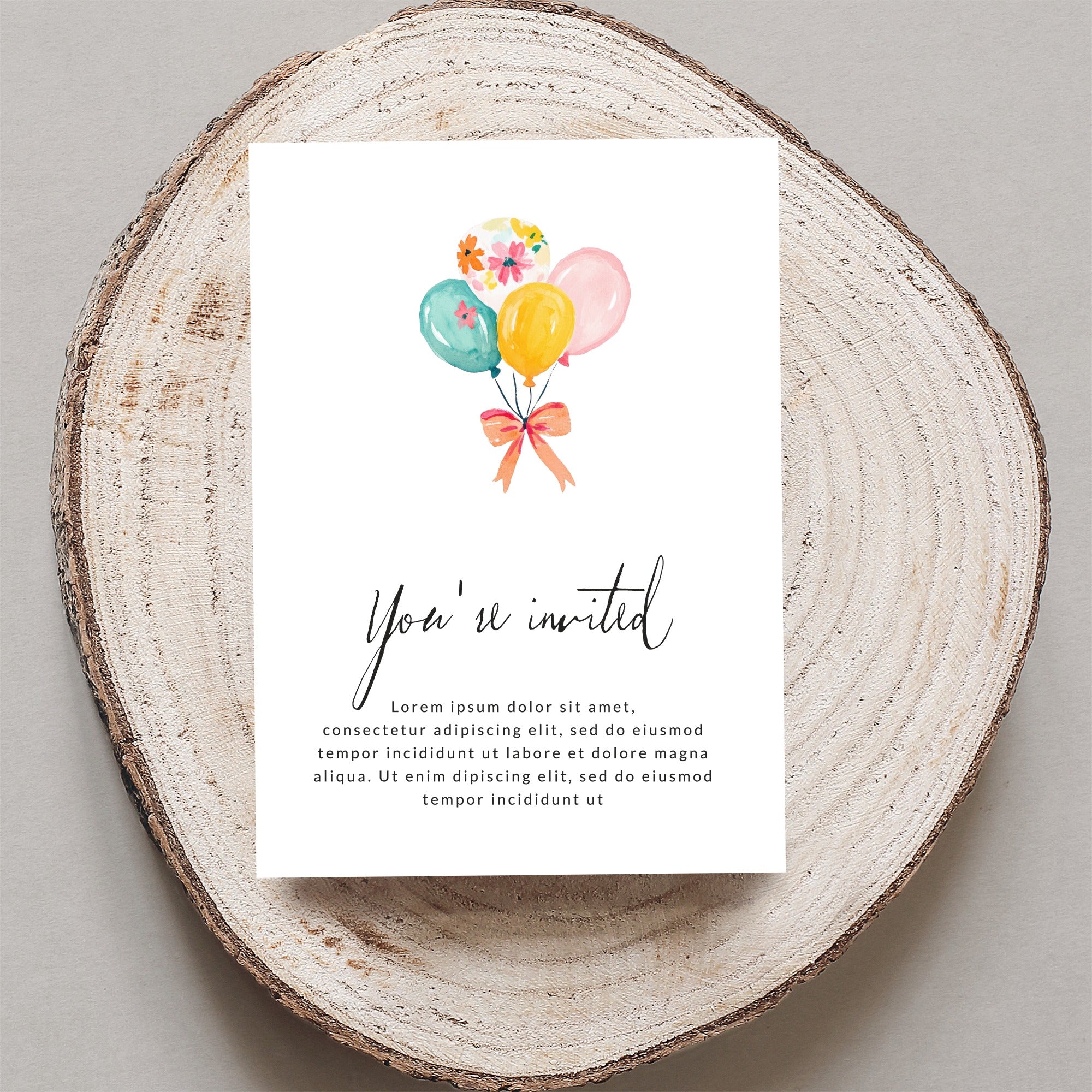 Invitation with "You're invited" text and colorful balloons.