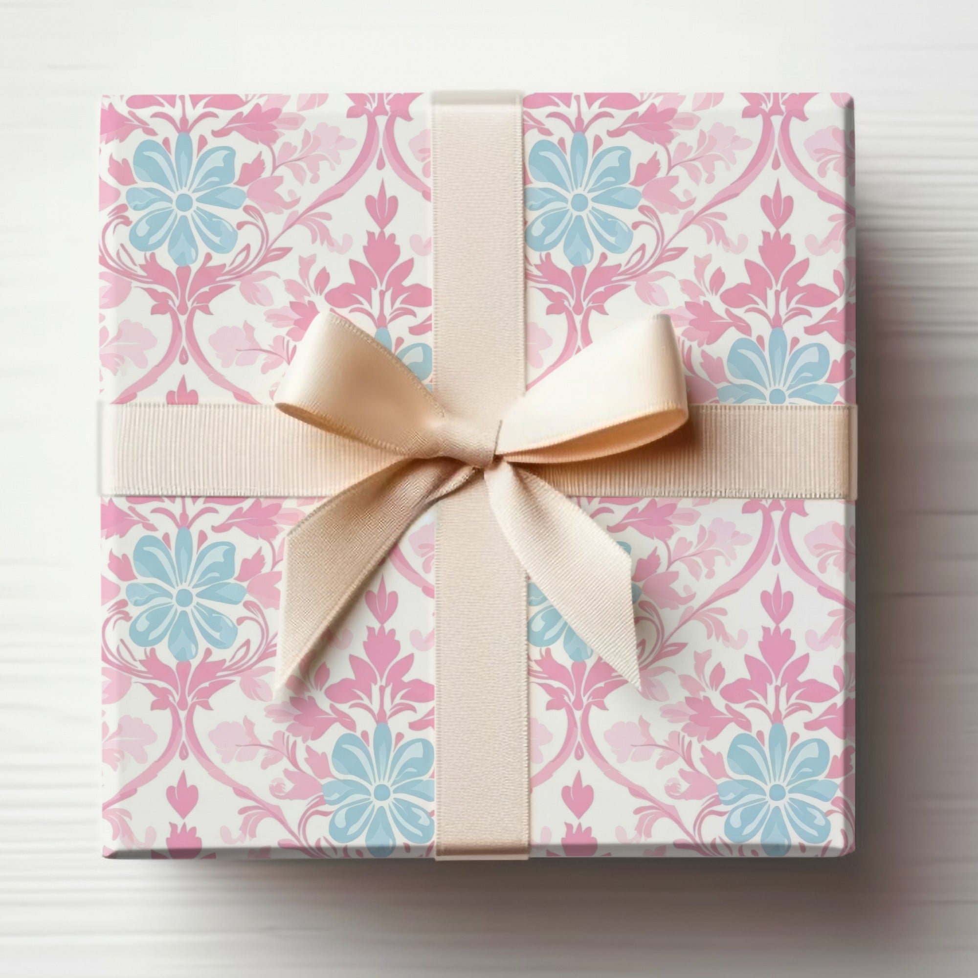 Gift box with pink and blue floral pattern, tied with a light brown ribbon.