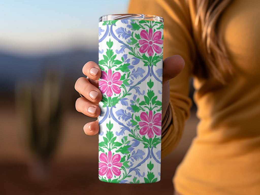 White tumbler with pink flowers and blue scrolling floral pattern.