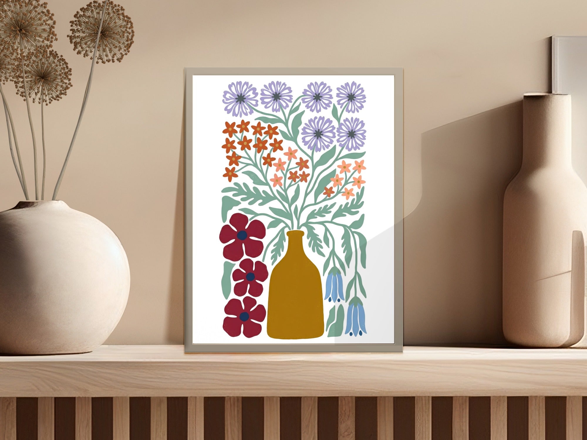 Abstract floral illustration in muted colors in a framed artwork on a shelf.