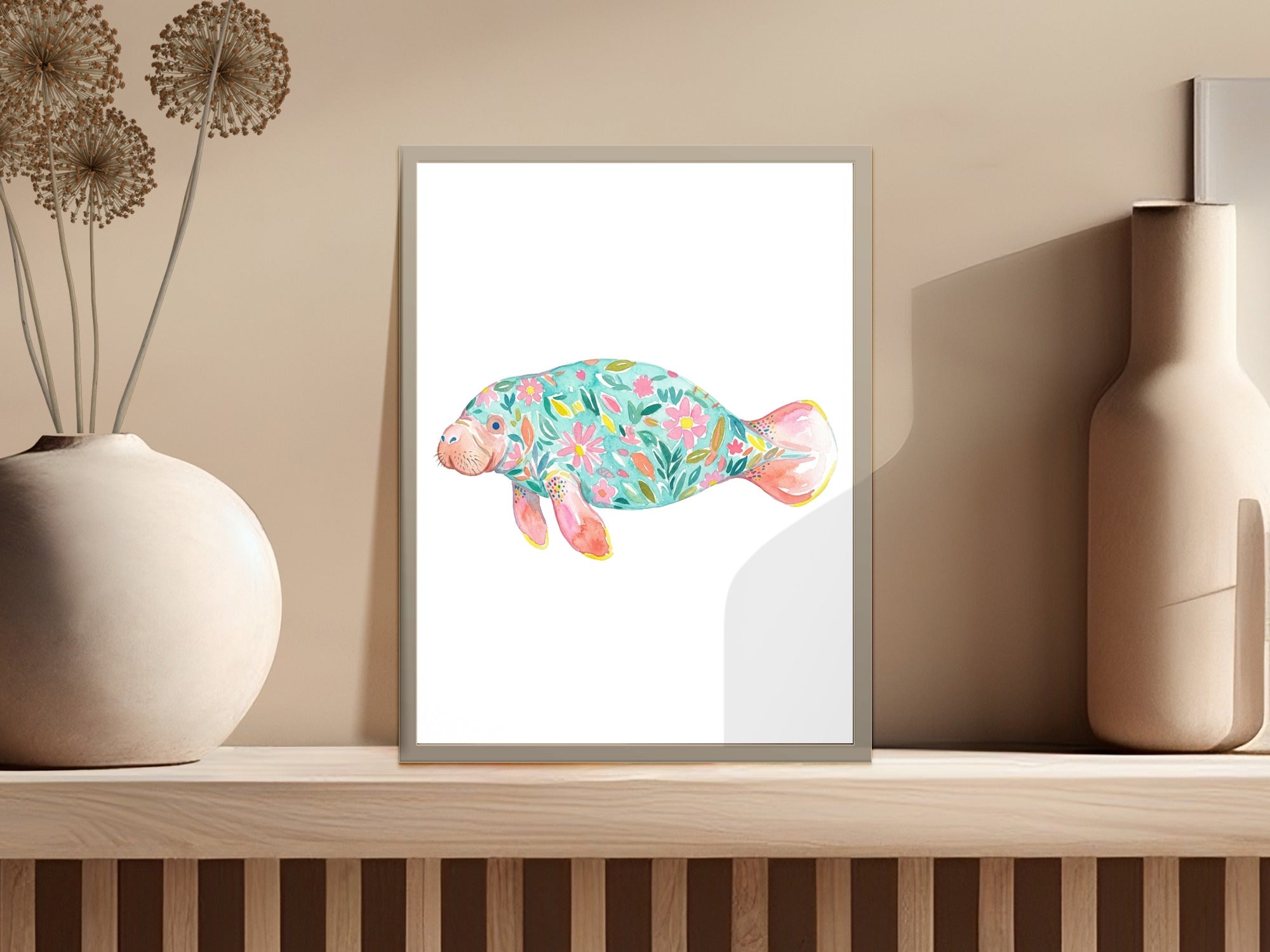 Watercolor manatee with colorful floral pattern on white background.