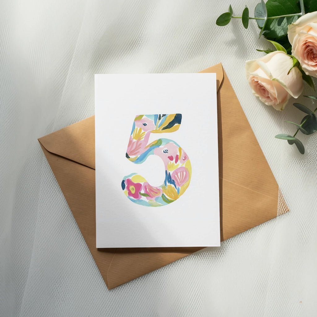 Card with colorful floral number 5 on brown envelope.