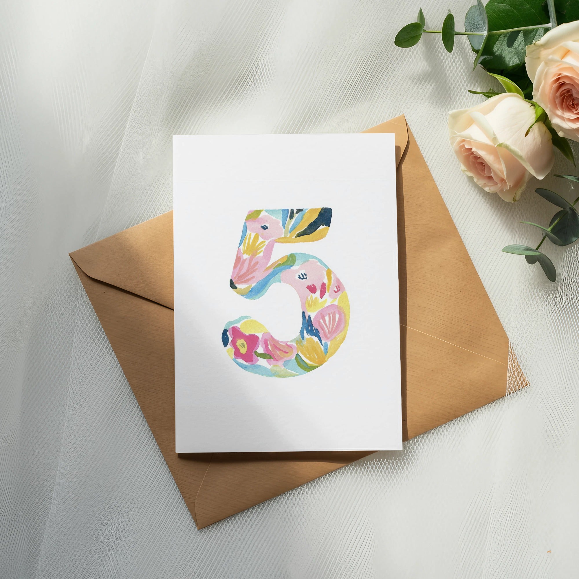 Card with colorful floral number 5 on brown envelope.