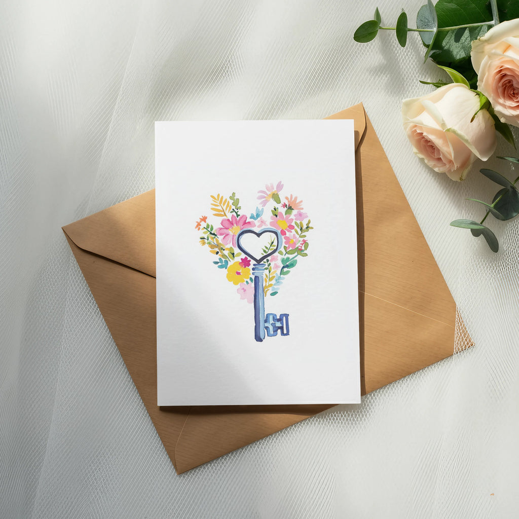 Card with heart-shaped floral design and vintage key, on brown envelope.