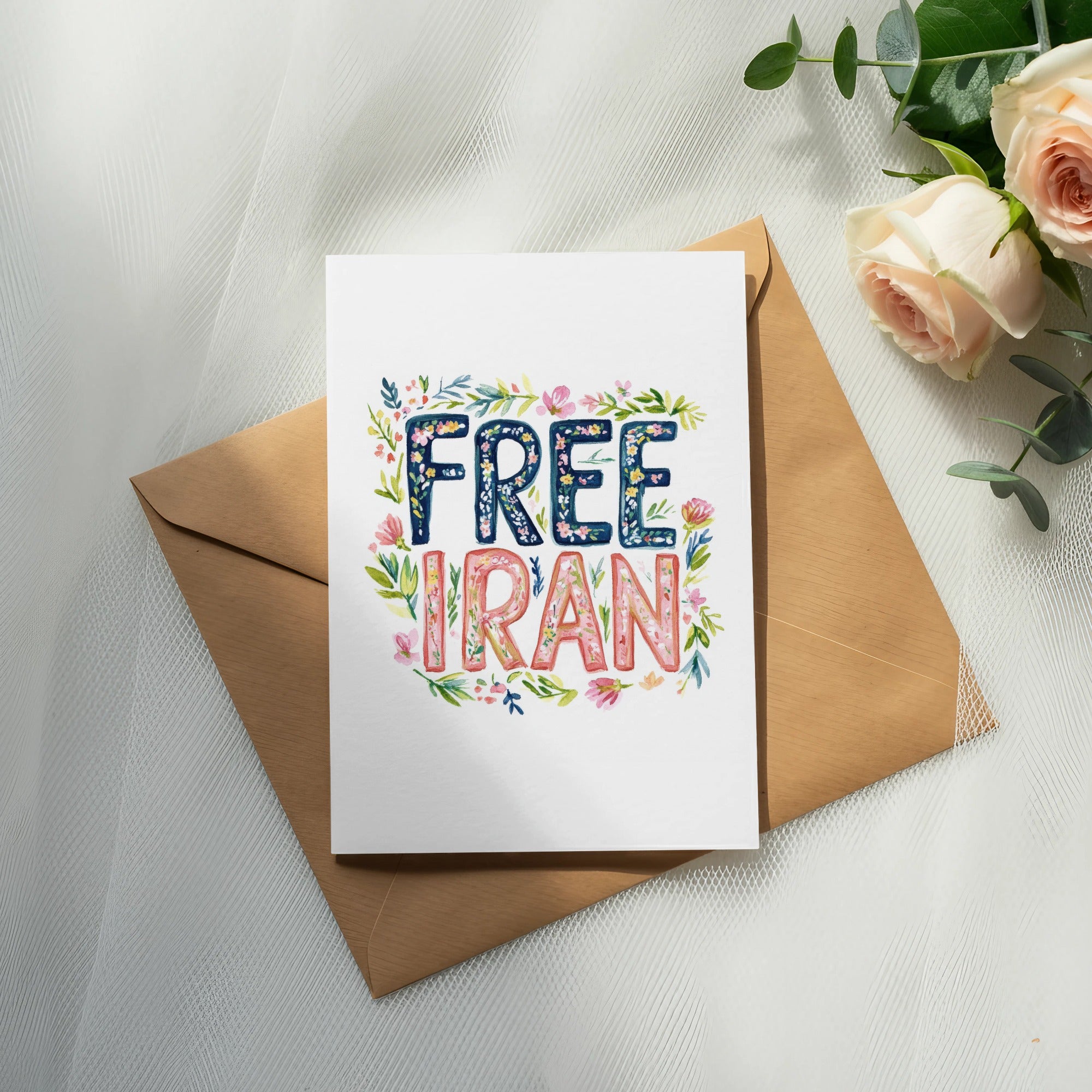 Card with "FREE IRAN" in floral lettering on an envelope with roses.