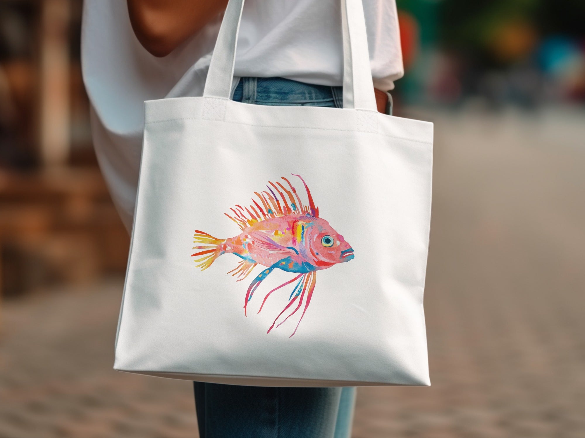 White tote bag with colorful watercolor painting of a fish.