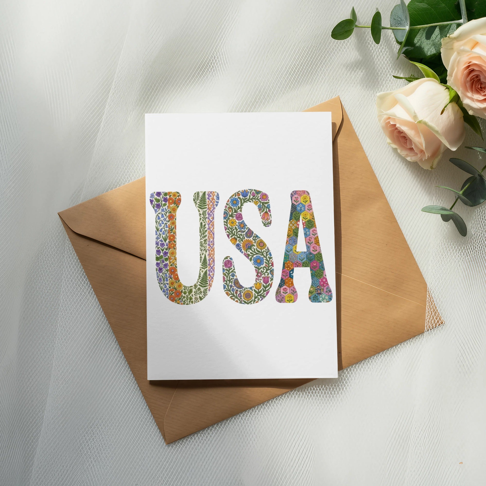 Card with "USA" in floral letters on a brown envelope.