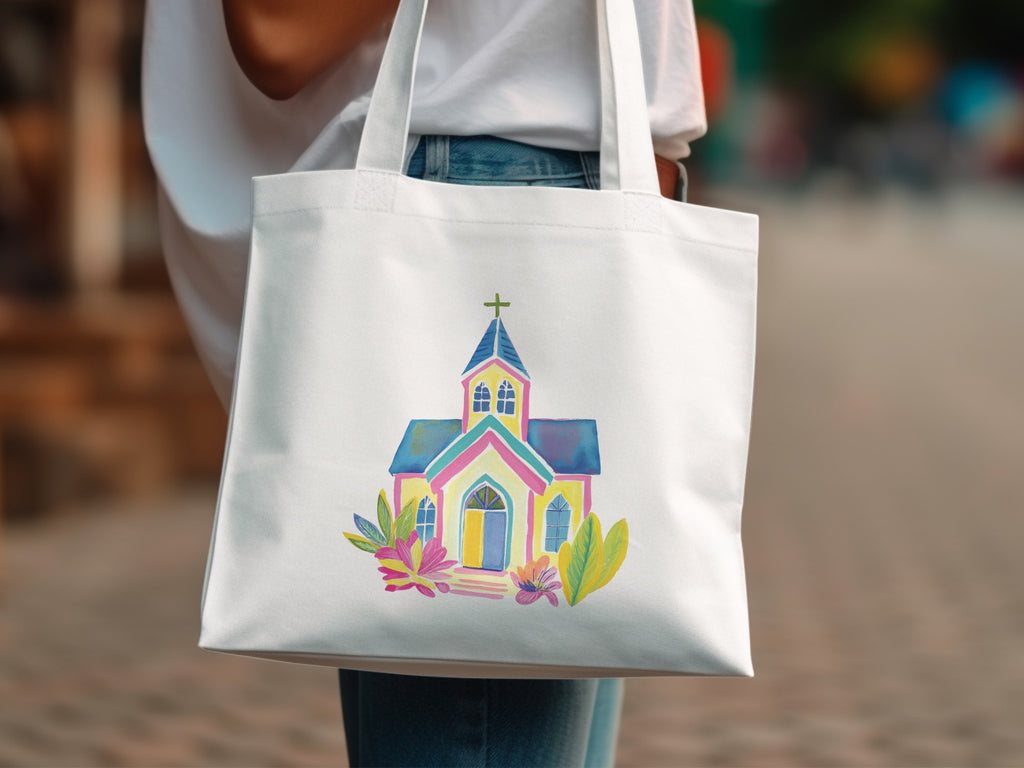 Colorful watercolor church illustration on a white canvas tote bag.