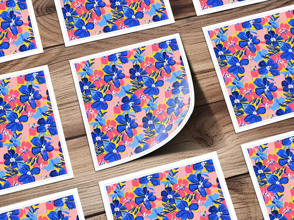 Floral pattern stickers with blue flowers and pink accents on a wooden background.