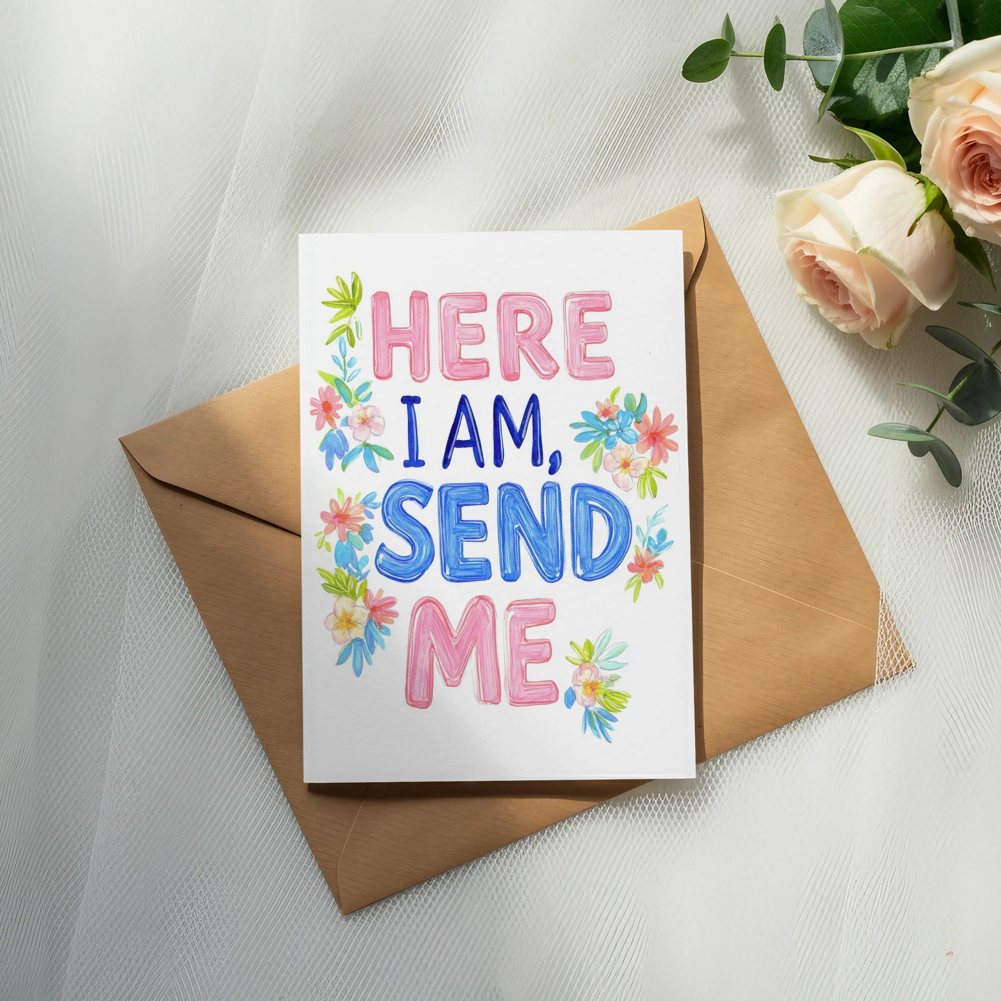 Greeting card with "HERE I AM, SEND ME" text and floral accents on a brown envelope.