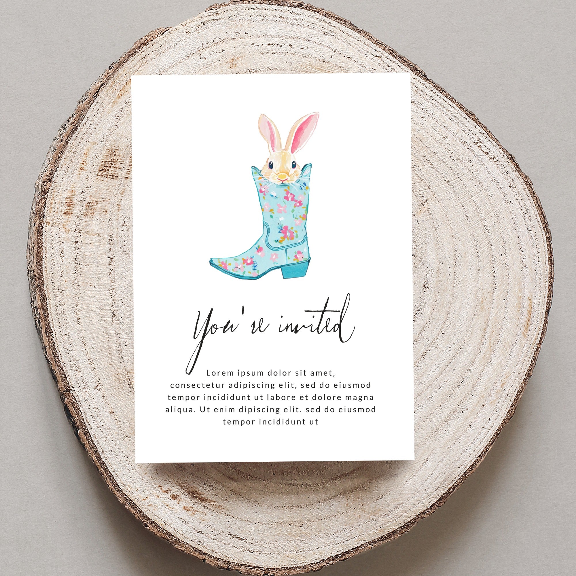 Invitation with floral cowboy boot and bunny ears, "You're invited".