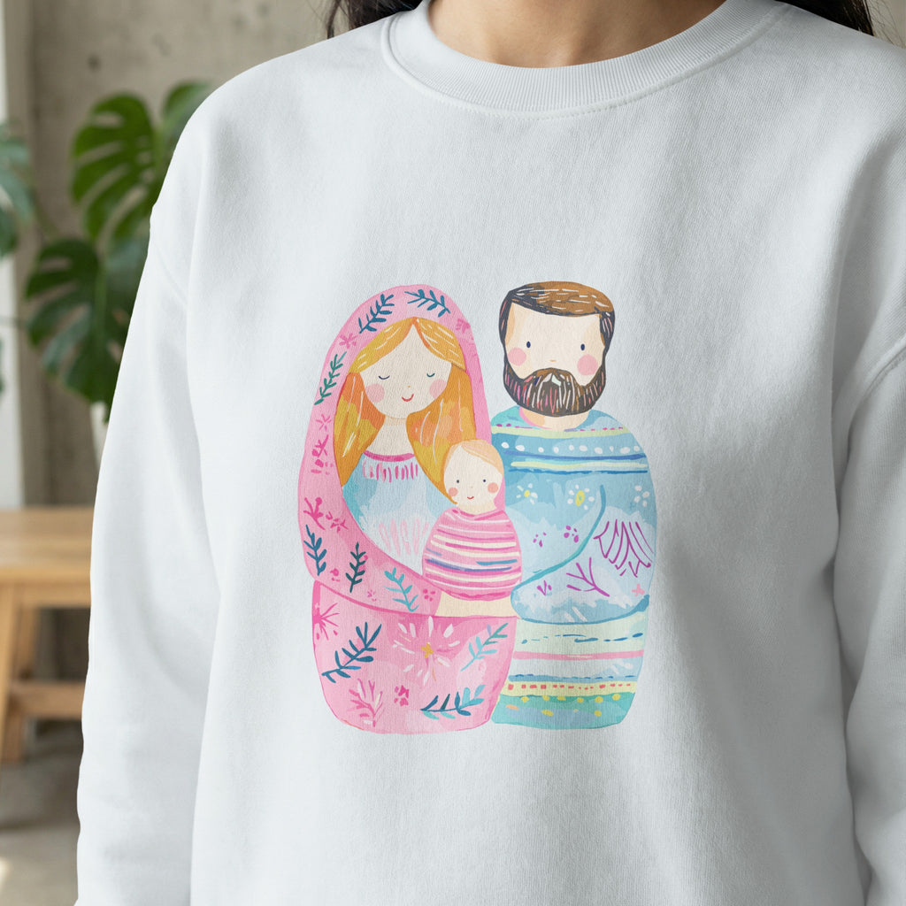 Matryoshka doll style illustration of a family with a baby on a white sweatshirt.