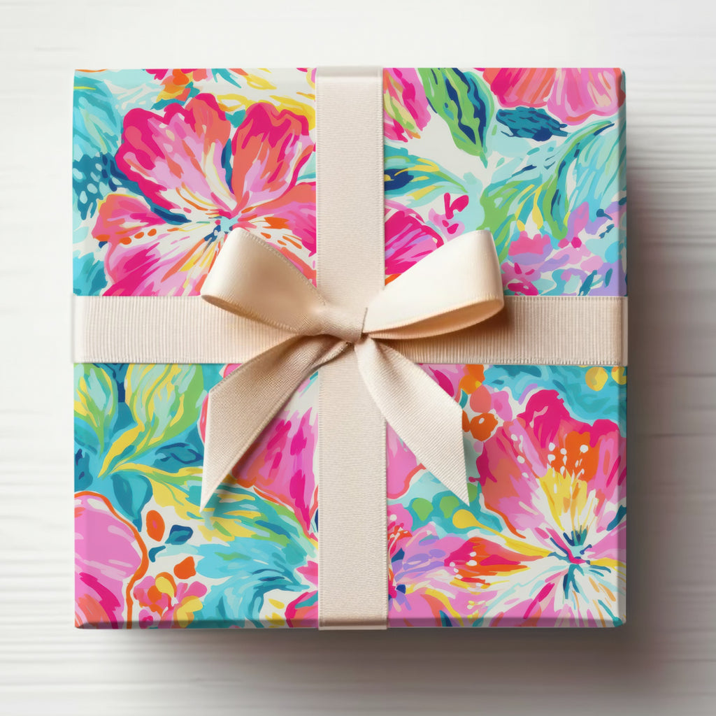Gift box with a floral pattern and a beige ribbon bow.